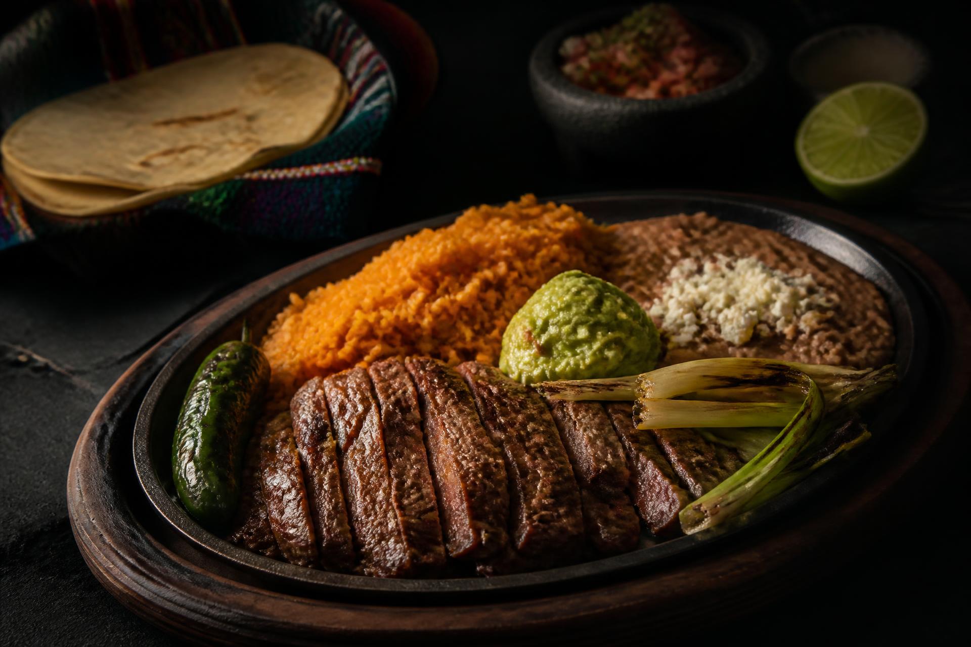 Sizzling carne asada plate with rice, beans, guacamole and warm tortillas at Asuncion Mexican Restaurant in Billings, Montana